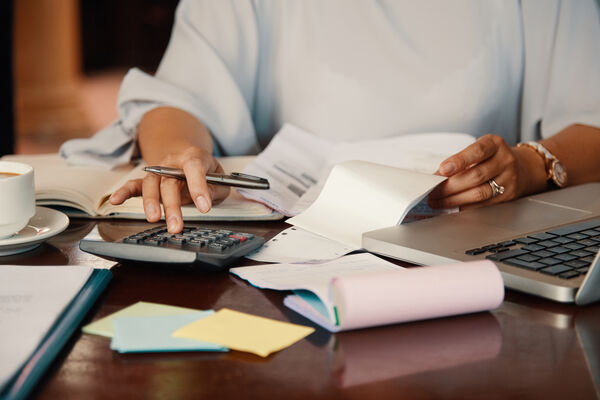 Women working out budget with calculator