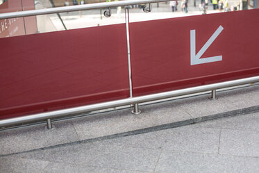 White arrow red background
